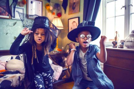 Two children are playing dress-up at home